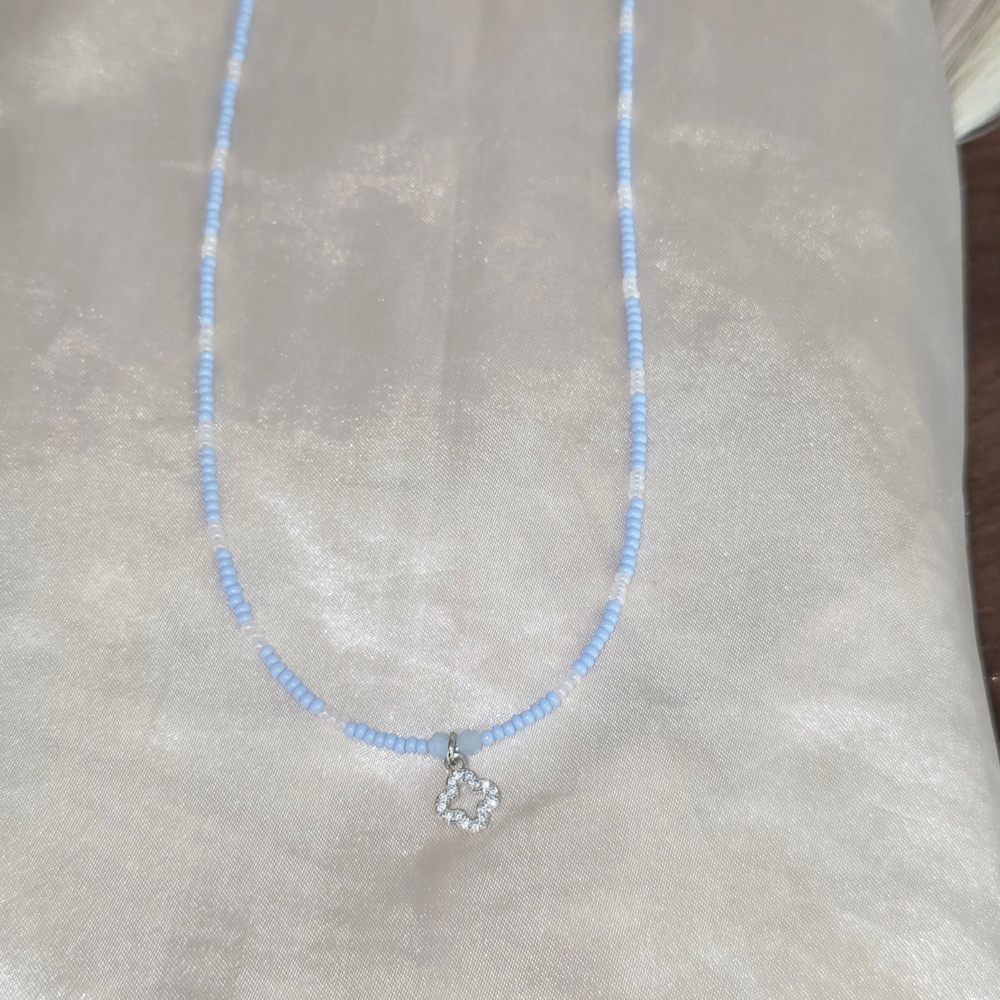 Beaded necklace with charm